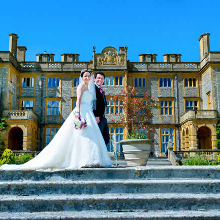 Bride and groom on steps at Eynsham Hall - Mark Sisley Photography