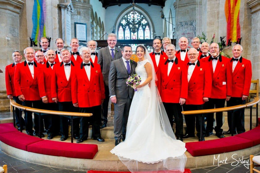 Bride and groom with choir - wedding at the Dairy Waddesdon Manor - Mark Sisley Photography