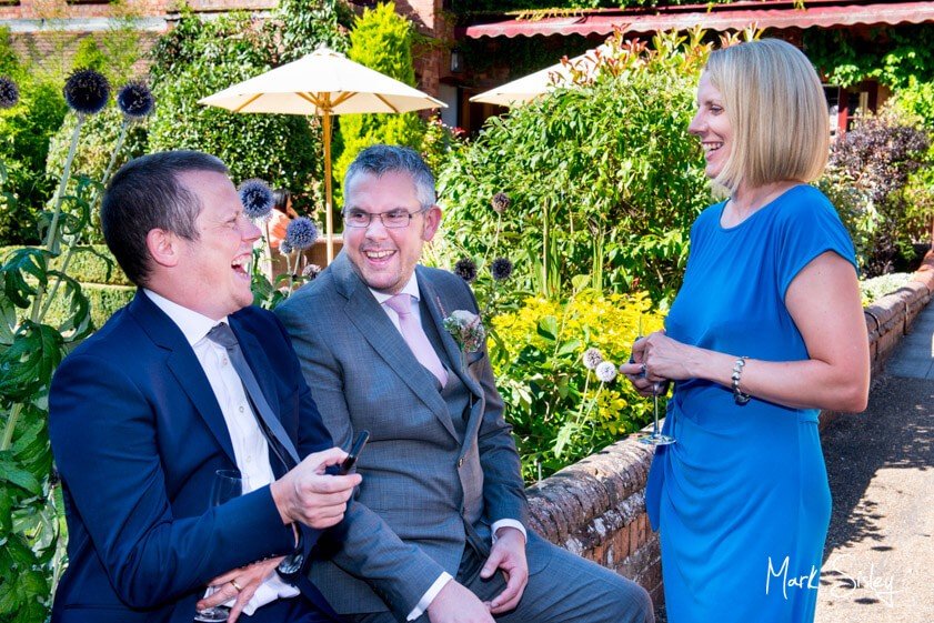 wedding guests laughing - wedding at The Five Arrows Waddesdon - Mark Sisley Photography