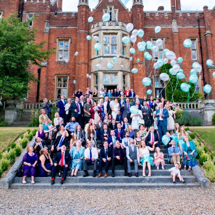 Wedding guests on steps at Latimer Estate Buckinghamshire