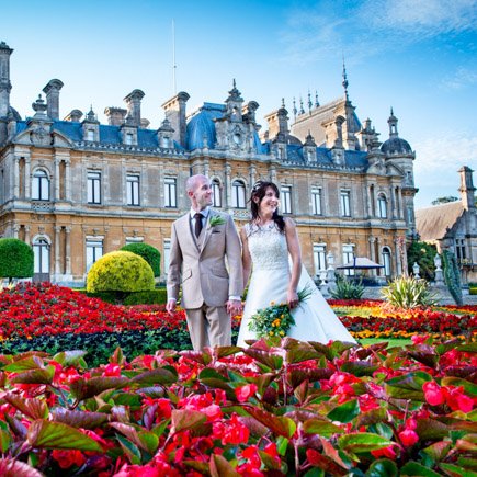 Bride and groom captured through the flowers at Waddesdon Manor Buckinghamshire