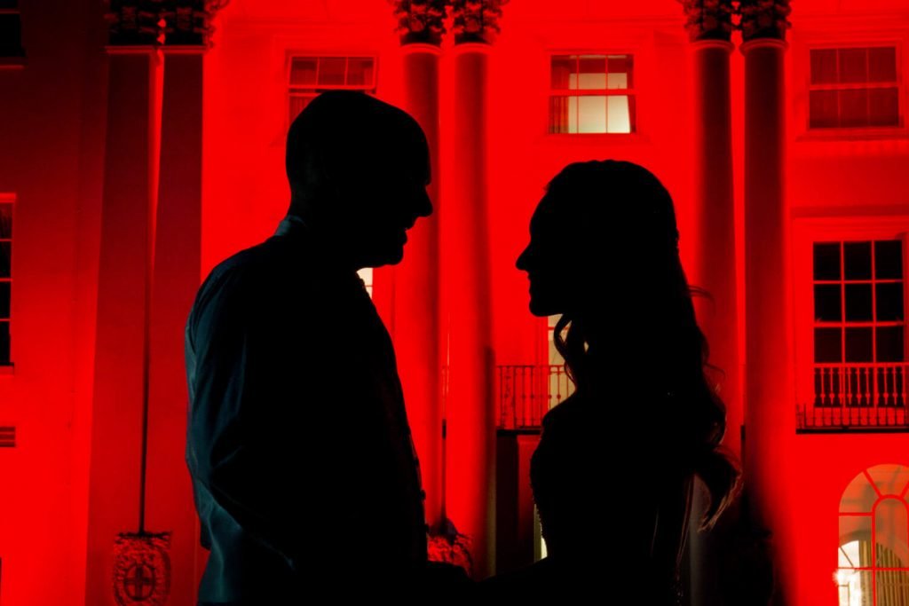 Beaumont Estate wedding photographs of the newlyweds in silhouette at the front of the floodlit hotel