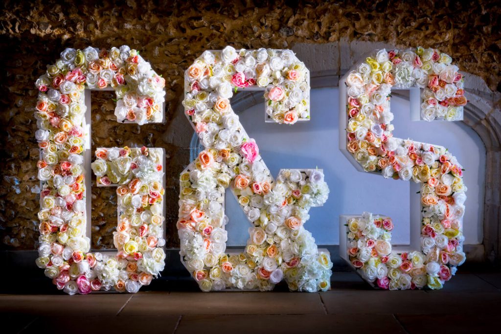 Summer's day wedding photography at Missenden Abbey - giant floral letters