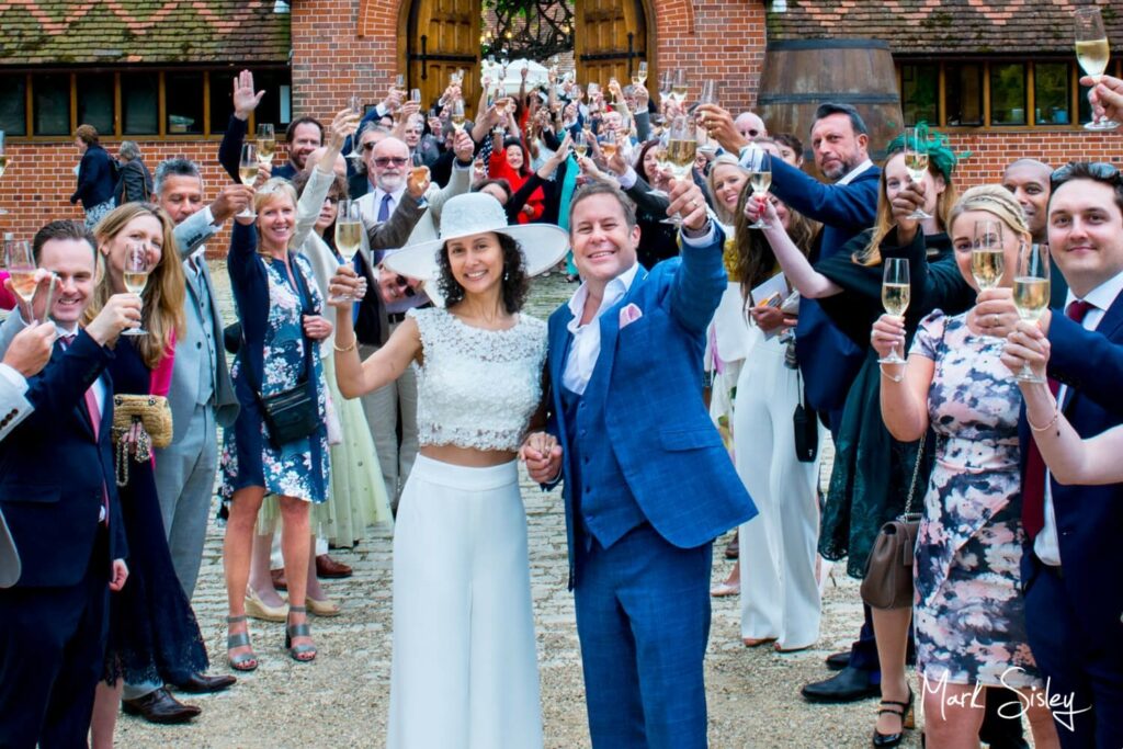 Dairy Waddesdon summer wedding pose of everyone with the champagne glasses