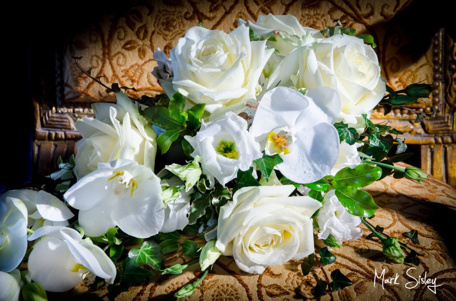 Choosing a wedding photographer - beautiful white bouquet on gold chair