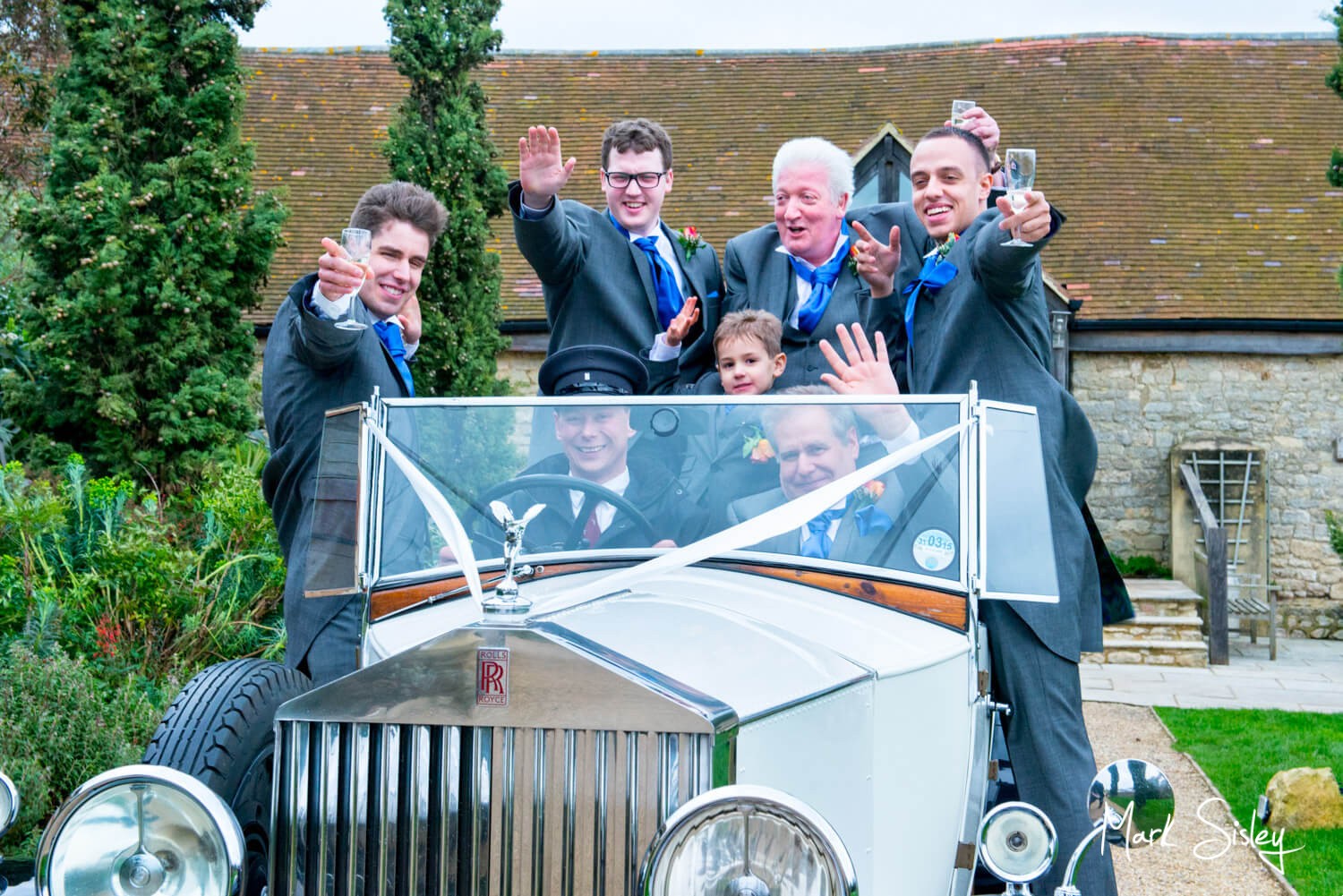 Vintage car and ushers at Notley Tythe Barn wedding