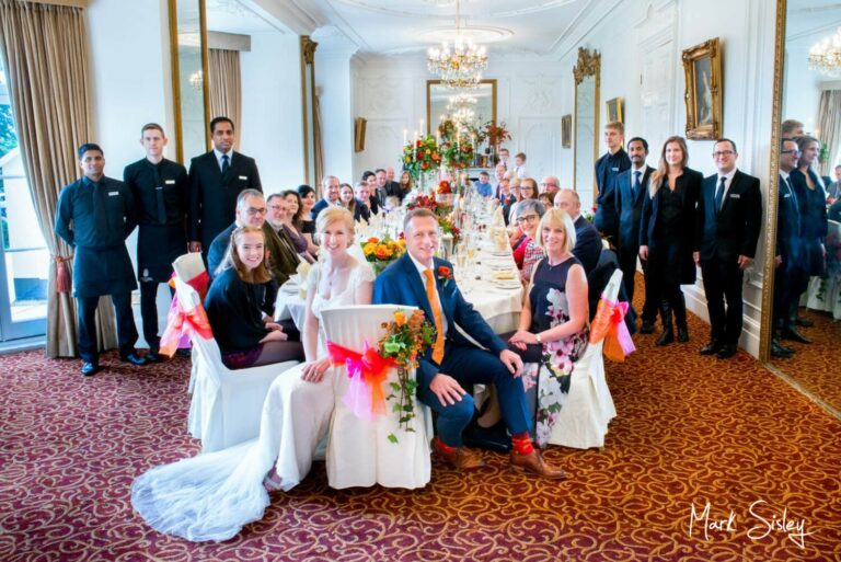 Large group pose at Taplow House autumn wedding