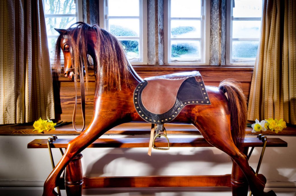 UK Holiday homes photography - rocking horse in the window in the Yorkshire Dales