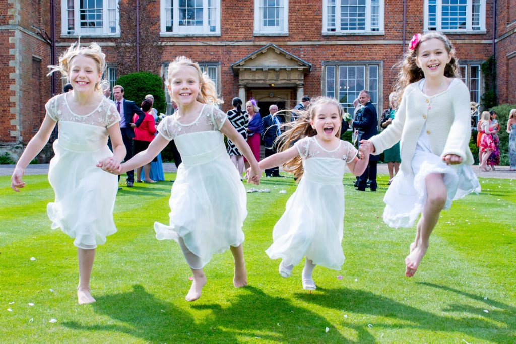 Photos at Dorton House wedding of the young girls running