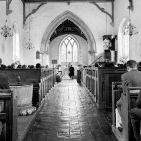 Black and white image of wedding ceremony in progress at Nether Winchendon church