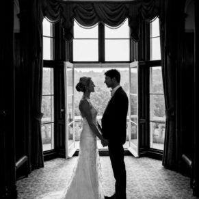 Black and white silhouette portrait of bride and groom in window at Latimer Estate wedding