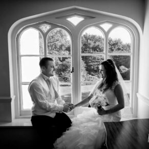 Black and white silhouette portrait of bride and groom in arched window at Taplow House Hotel wedding
