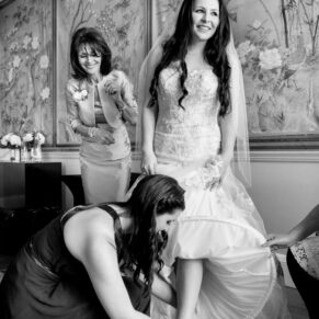 Black and white image of bride getting ready at Eynsham Hall wedding