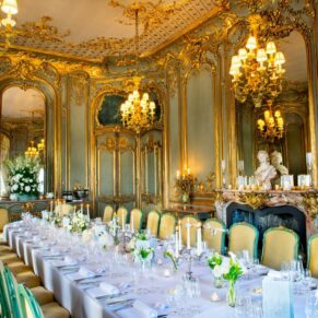 Luxurious gilt French dning room at Cliveden House, laid out for a wedding breakfast with long table by Mark Sisley Photography