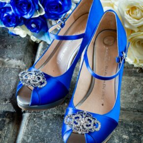 Close-up image of blue satin wedding shoes with rhinestones at Brocket Hall wedding
