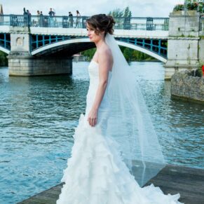 Bride with river Thames in background at Sir Christopher Wren House Hotel Windsor wedding