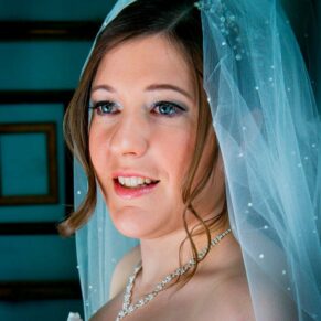 Window-lit photography of bride at Stoke Place wedding