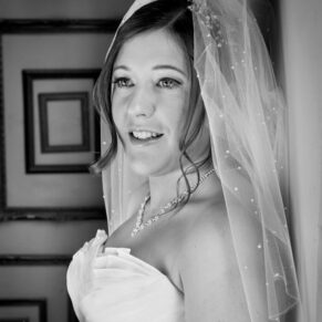Black and white window-lit portrait of bride at Stoke Place wedding