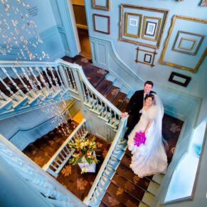 Bride and groom on staircase at Stoke Place wedding