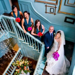 Bride and bridesmaids on stairs at Stoke Place wedding