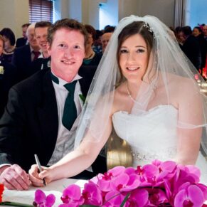 Bride and groom signing register at Stoke Place wedding