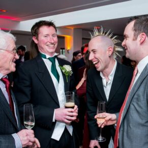 Reportage image of men chatting at Stoke Place wedding