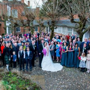 Outdoor picture of bride and groom and wedding guests at Stoke Place wedding