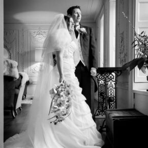 Black and white full length portrait of bride and groom at Stoke Place wedding