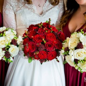 Bride with floral bouquet of red roses at Taplow House Hotel wedding
