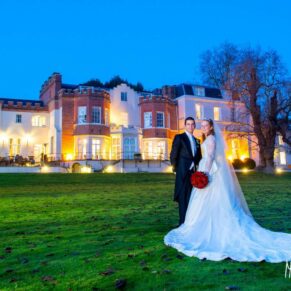 Twilight image of bride and groom on the lawn at their Taplow House Hotel wedding
