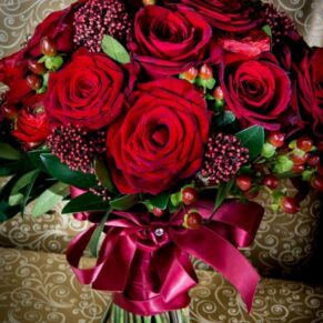 Red roses in bridal bouquet at Taplow House Hotel wedding