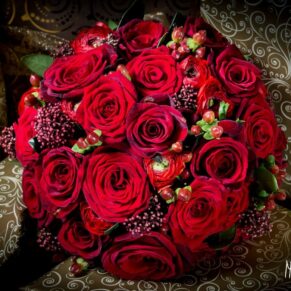 Red roses in bridal bouquet at Taplow House Hotel wedding