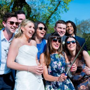 Photography of guests taking a selfie on the grass at a Taplow House Hotel wedding