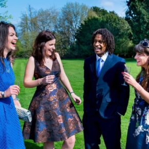 Photography of guests relaxing on the grass at a Taplow House Hotel wedding