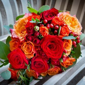 Bridal bouquet of orange and red at Taplow House Hotel wedding