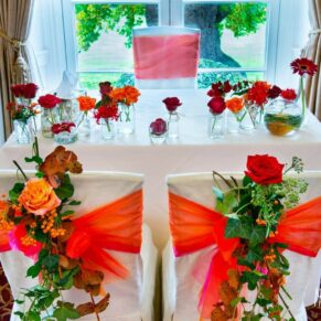 Taplow House Hotel prepared for wedding ceremony with orange and red flowers
