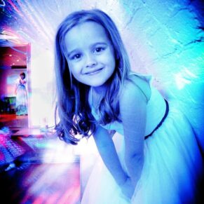 Backlit disco image of little girl dancing at Taplow House Hotel wedding