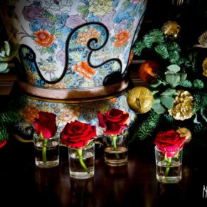 Red and gold Christmas floral arrangements at Taplow House Hotel wedding