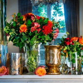 Wedding decorated mantlepiece at Taplow House Hotel wtih rich red and yellow roses, alstroemeiria and chillis