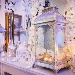 Wedding mantlepiece at Taplow House Hotel with pewter lanterns, white orchids and tea lights