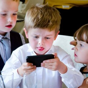 Fun informal image of little boy playing at Taplow House Hotel wedding