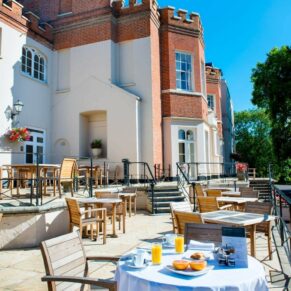 Exterior image of Taplow House hotel terrace laid out for a wedding