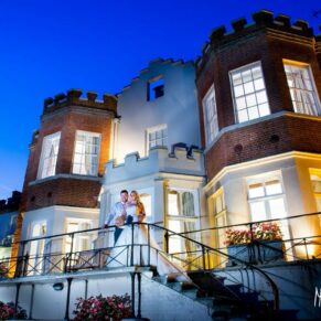 Twilight photography of bride and groom on terrace at Taplow House wedding