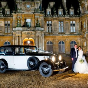Bride and groom and Rolls Royce wedding car at Waddesdon Manor winter wedding