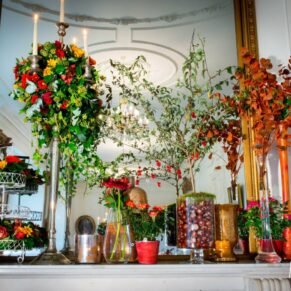 Floral arrangement in mirror at Taplow House Hotel winter wedding