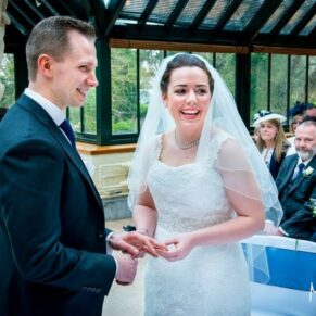 Bride and groom exchanging vows in front of their wedding guest at The Dairy Waddesdon Manor