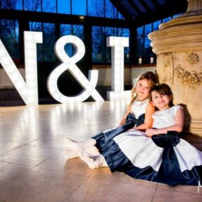 Magical Dairy Waddesdon Manor wedding image of the flower girls with the giant illumiinated letters