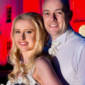 Beaumont Estate wedding photographs of the newlyweds at the front of the floodlit hotel