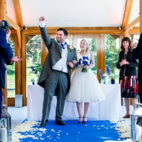 Brocket Hall wedding photographs of the groom punching the air after the marriage ceremony