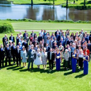 Brocket Hall wedding photographs of all the wedding guests from up high with views of the lake